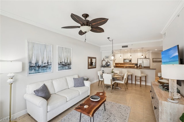 living room featuring crown molding, light tile patterned floors, and ceiling fan