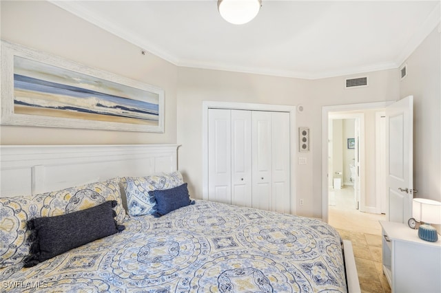 bedroom with ornamental molding, light tile patterned flooring, and a closet