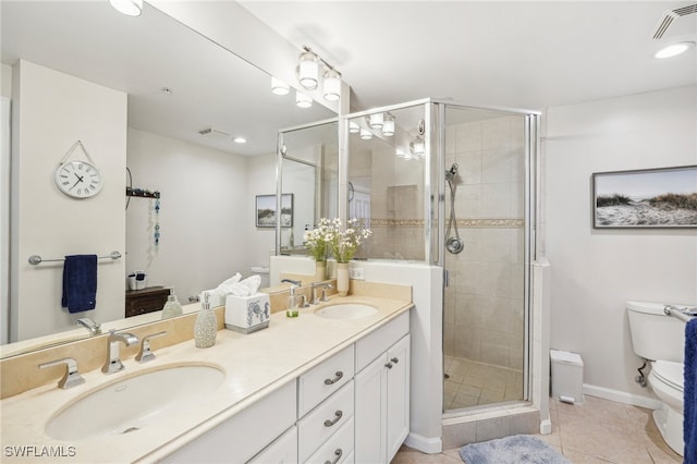 bathroom with vanity, toilet, tile patterned flooring, and an enclosed shower