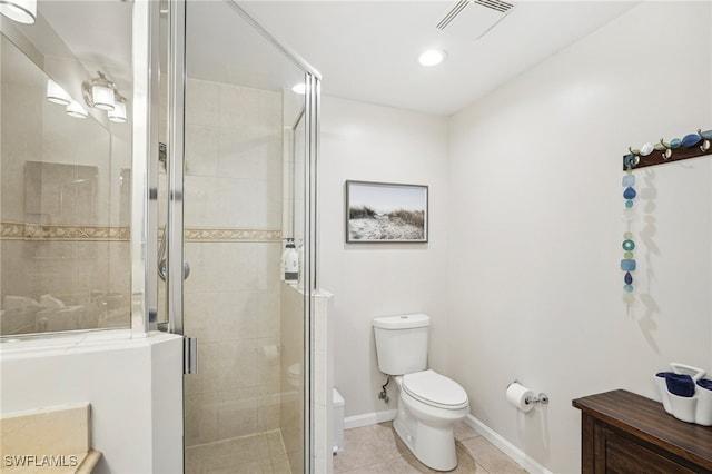 bathroom featuring tile patterned flooring, toilet, and walk in shower