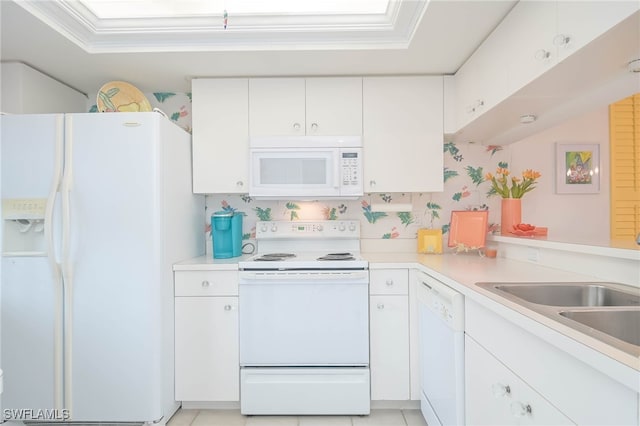 kitchen featuring white appliances, sink, kitchen peninsula, white cabinetry, and crown molding