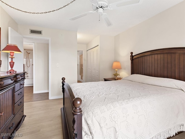 bedroom featuring light hardwood / wood-style flooring, a closet, and ceiling fan