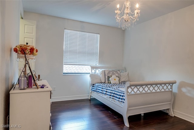 bedroom featuring an inviting chandelier and dark hardwood / wood-style floors