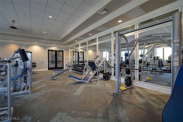 exercise room featuring a drop ceiling, carpet flooring, and french doors