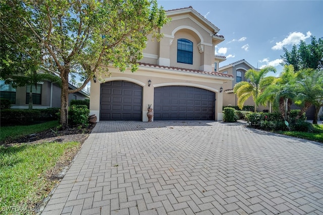 mediterranean / spanish-style house featuring a garage