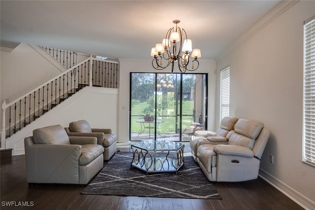 living room featuring ornamental molding, dark hardwood / wood-style floors, and an inviting chandelier