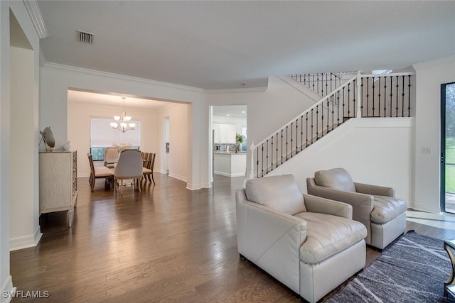 living room featuring crown molding, a chandelier, and dark hardwood / wood-style flooring