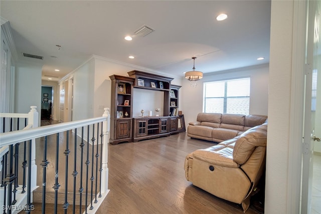 living room with ornamental molding and wood-type flooring