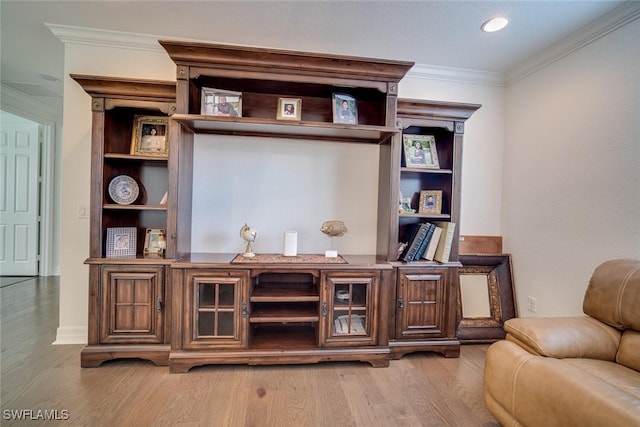 interior space featuring crown molding and hardwood / wood-style flooring