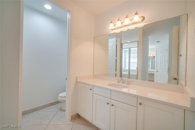 bathroom featuring toilet, vanity, and tile patterned floors