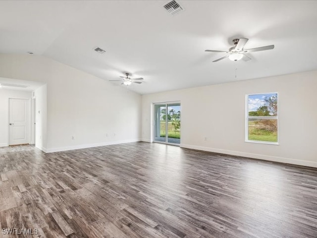 spare room with a healthy amount of sunlight and dark hardwood / wood-style floors