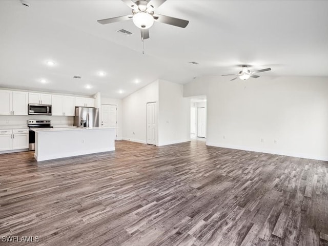 unfurnished living room with ceiling fan, lofted ceiling, and hardwood / wood-style floors