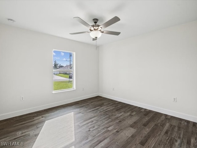 spare room featuring ceiling fan and dark hardwood / wood-style flooring