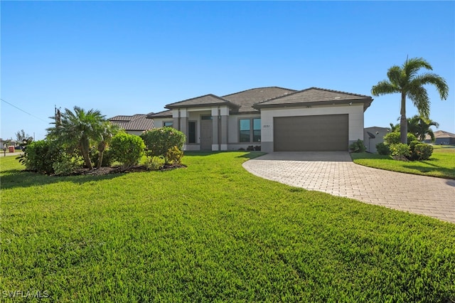 view of front of home featuring a front yard and a garage