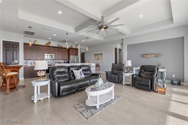 living room with beam ceiling, light tile patterned floors, coffered ceiling, and ceiling fan