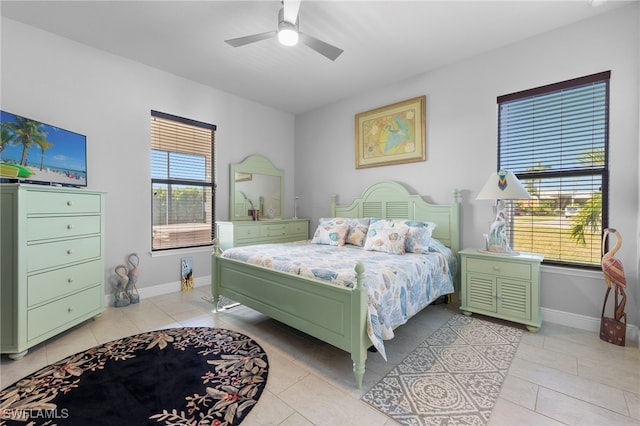 bedroom with ceiling fan and light tile patterned flooring