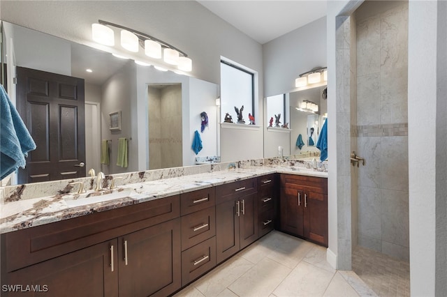 bathroom with vanity, tile patterned floors, and tiled shower