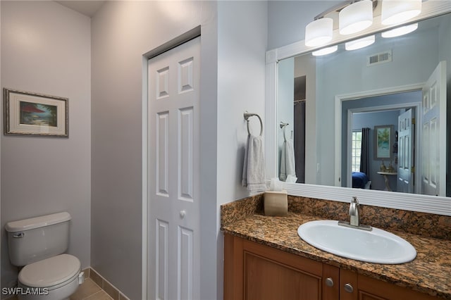 bathroom with vanity, toilet, and tile patterned flooring