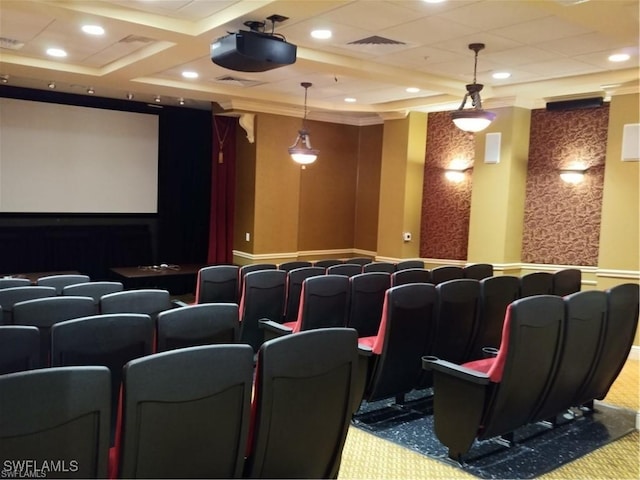 carpeted cinema room featuring ornamental molding