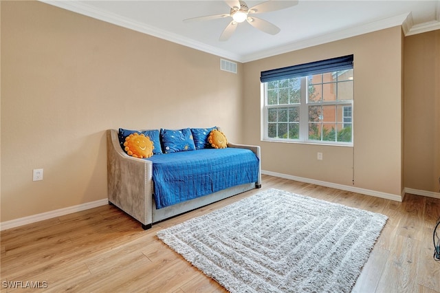 bedroom featuring ceiling fan, light hardwood / wood-style floors, and crown molding