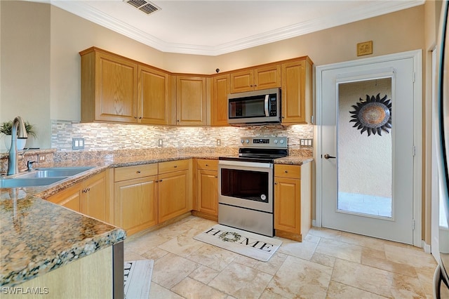 kitchen with backsplash, sink, crown molding, appliances with stainless steel finishes, and light stone counters