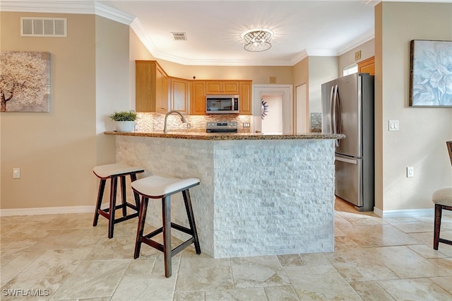 kitchen with light stone counters, backsplash, kitchen peninsula, crown molding, and appliances with stainless steel finishes