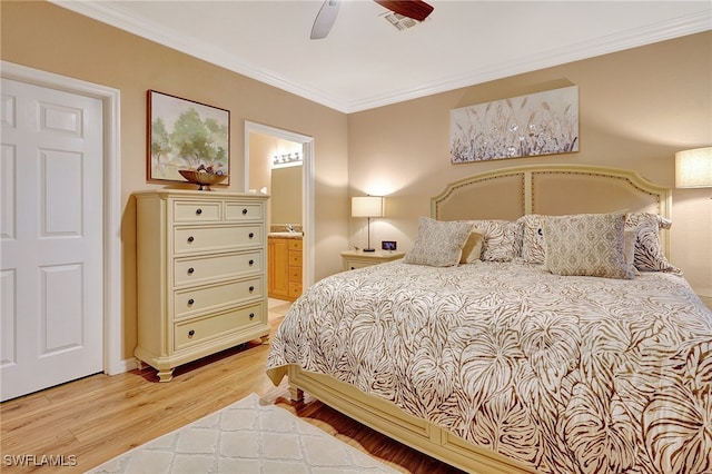 bedroom with ceiling fan, light hardwood / wood-style floors, crown molding, and ensuite bath