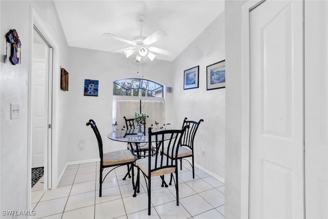 dining room with lofted ceiling, ceiling fan, and light tile patterned flooring