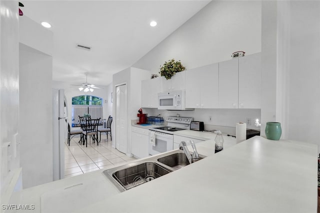 kitchen with vaulted ceiling, light tile patterned flooring, white cabinetry, ceiling fan, and white appliances