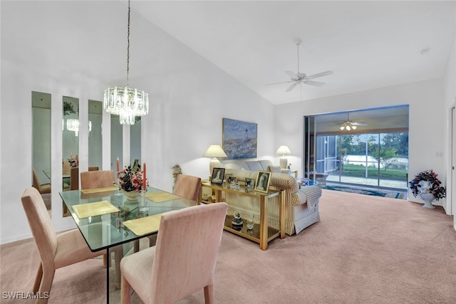 dining area featuring high vaulted ceiling, light carpet, and a notable chandelier