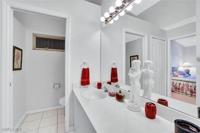 bathroom featuring vanity, tile patterned floors, and toilet