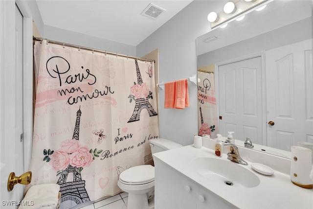 bathroom featuring tile patterned flooring, vanity, curtained shower, and toilet