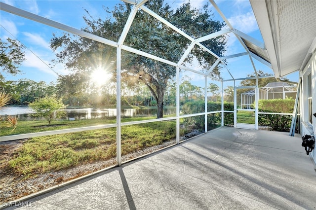 unfurnished sunroom featuring a water view