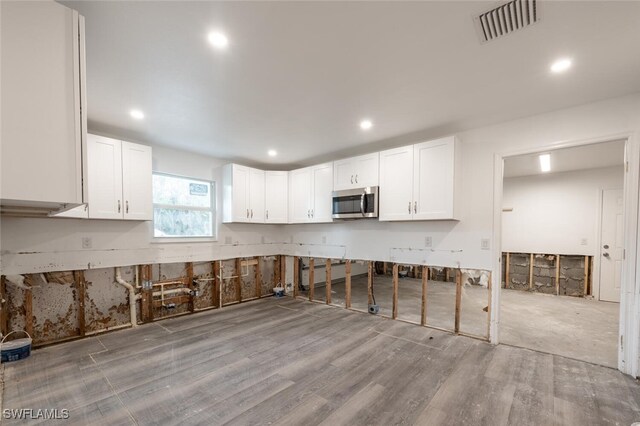 kitchen featuring light hardwood / wood-style floors and white cabinets