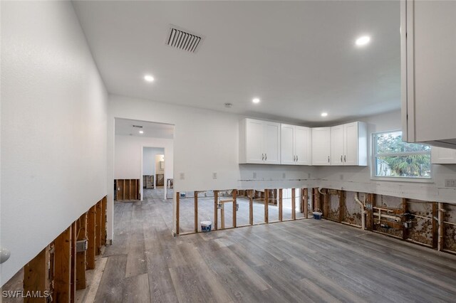 kitchen featuring white cabinetry and wood-type flooring