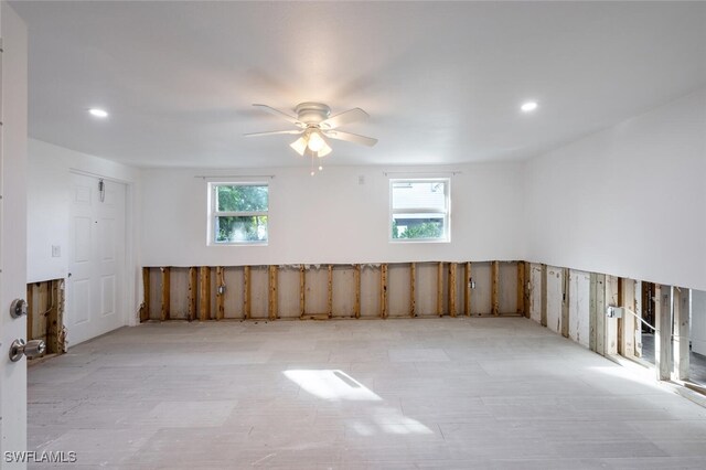 spare room featuring plenty of natural light and ceiling fan