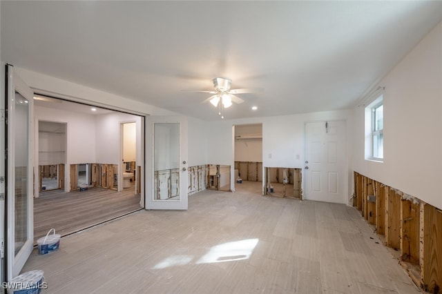 unfurnished room with wooden walls and ceiling fan