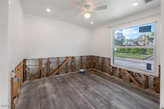 spare room with ceiling fan and dark hardwood / wood-style floors