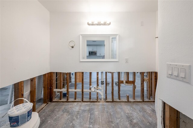 bathroom featuring hardwood / wood-style floors and toilet