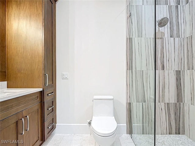 bathroom with vanity, toilet, and a tile shower