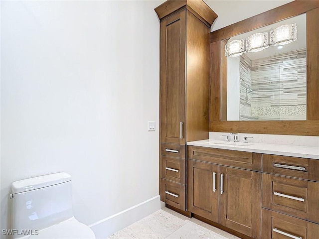 bathroom featuring vanity, tile patterned floors, and toilet