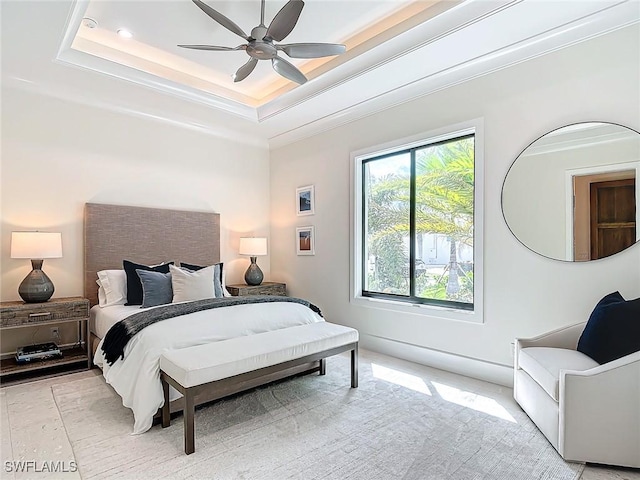 bedroom with ceiling fan, ornamental molding, and a raised ceiling