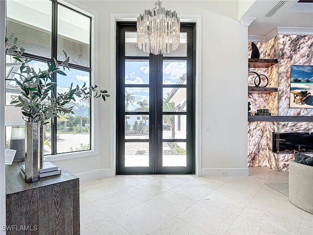 entrance foyer featuring an inviting chandelier and french doors