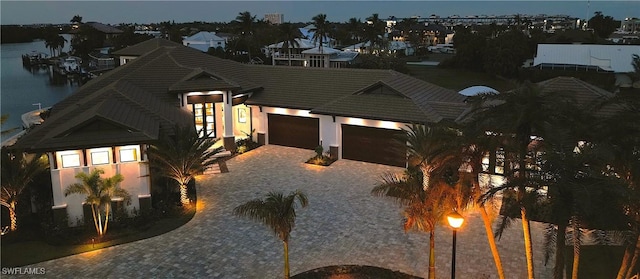 view of front of house featuring a garage and a water view