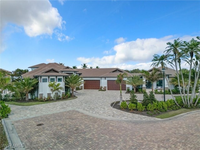 14201 Bay Dr, Fort Myers, FL 33919 - view of front facade featuring decorative driveway, a garage, and stucco siding