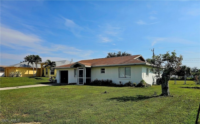 ranch-style house featuring a garage and a front yard