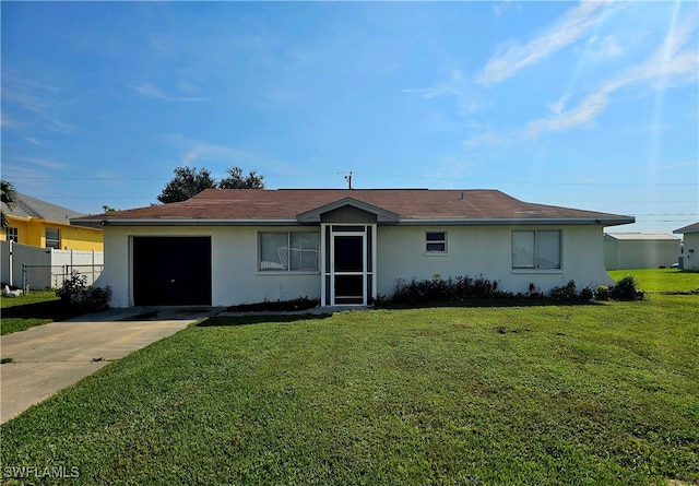 single story home featuring a garage and a front yard