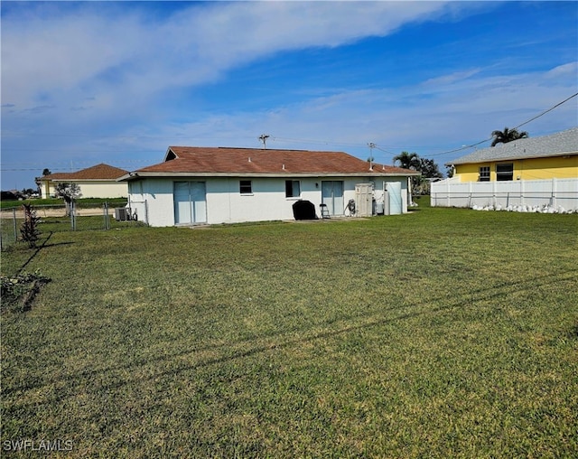 back of house with a yard