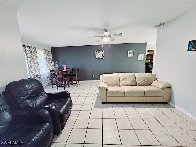 tiled living room with ceiling fan