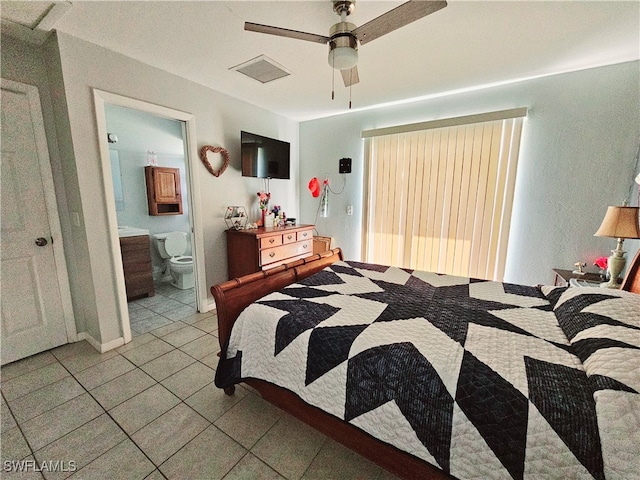 bedroom featuring ceiling fan, light tile patterned floors, and connected bathroom